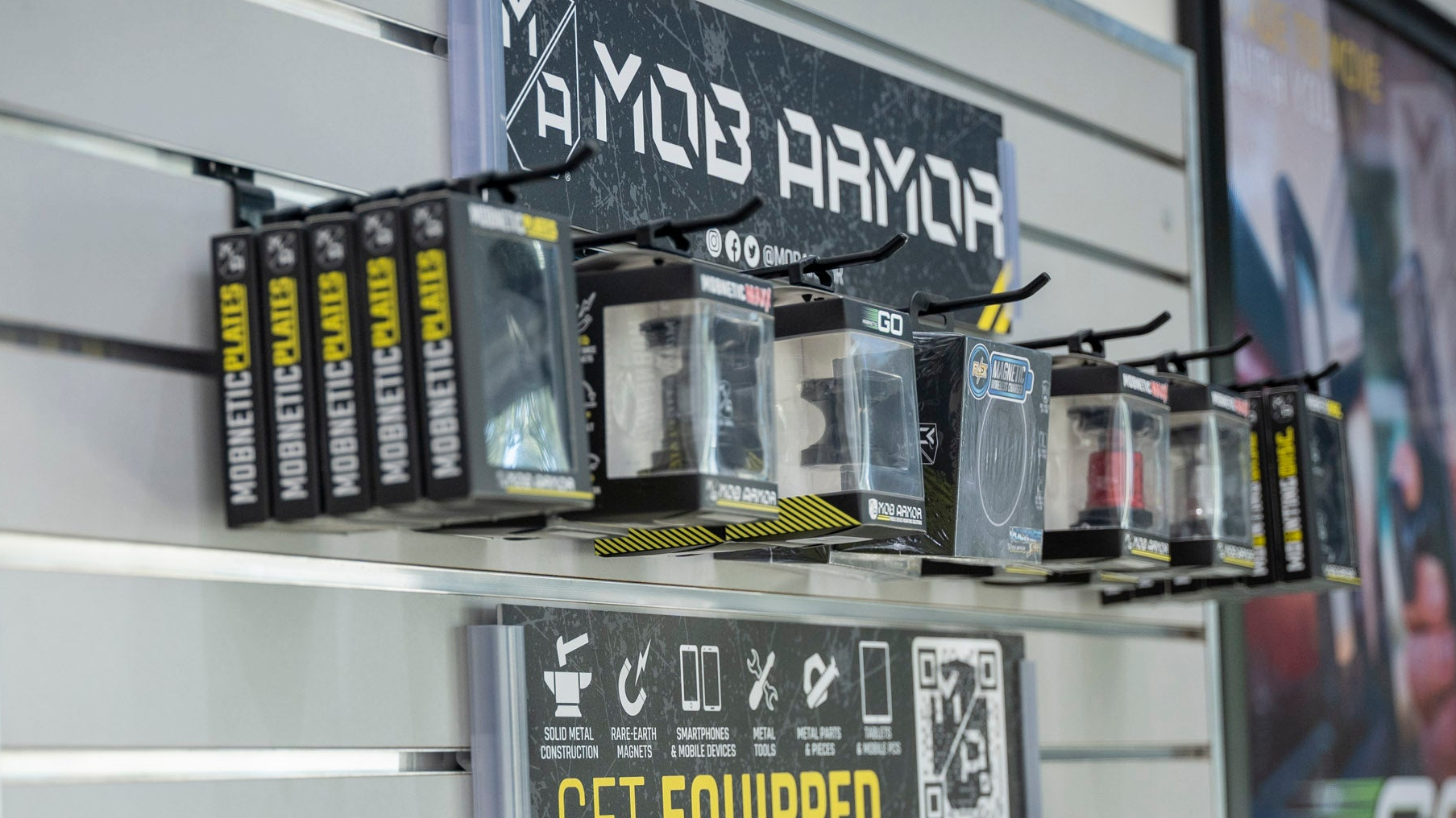 Display of MOB ARMOR products with a sign encouraging viewers to 'GET EQUIPPED'.